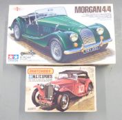 Two model kits Tamiya 1:24 scale Morgan 4/4 24170 and Matchbox 1:32 scale M.G.TC Sports PK-306, both