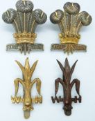 Four British Army Welsh Horse and Royal Regiment of Wales metal hat badges