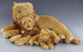 Three graduated Steiff lions all with shaved mohair and tipped manes, largest 80cm long.