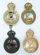 Four British Army Hertfordshire Regiment metal cap badges including a non voided example