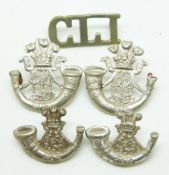 Five British Army Ceylon Light Infantry metal badges in two pairs plus a single shoulder title