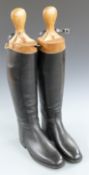 A pair of leather riding boots with wooden trees, 