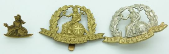 Three British Army Norfolk Regiment badges, two WWI forage cap examples and a pre-1896 field service