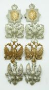 Eight British Army King's Dragoon Guards metal collar badges in four different pairs