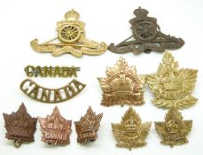 Nine Canadian Army Royal Artillery and General Service metal hat and collar badges and two