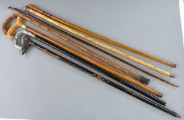 Six walking sticks including a glass example, largest 108cm
