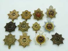 Twelve British Army Royal Army Service Corps metal badges including officer's enamel and a non
