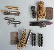 A collection of Lee Enfield rifle accessories including ammunition clips, cleaning kit etc.