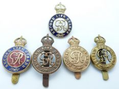 Five British Army Second Life Guards metal cap badges including two enamelled examples