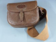 A vintage canvas and brown leather shotgun cartridge bag.