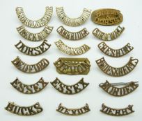 Eighteen British Army County Regiments metal shoulder titles including those for the Bedford