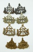 Eight British Army Reconnaissance Corps metal badges, one pair not voided.
