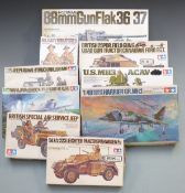 Nine Tamiya 1:35 scale plastic model kits including Flak 36/37, M113 ACAV, and Willys MB, all in