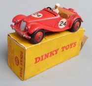 Dinky Toys diecast model M.G. Midget Sports with red body and hubs, tan interior, white driver and