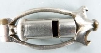 Nickel plated folding combined 12 bore shotgun cartridge extractor and dog whistle.