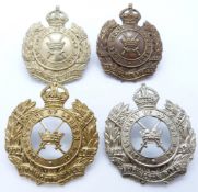 Four British Army 10th County of London Battalion Paddington Rifles metal cap badges including two