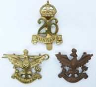 Three British Army 26th Hussars metal cap badges including an officer's example