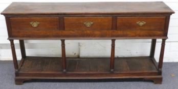 Oak three drawer dresser raised above single shelf on bracket feet, W169 x D40cm x H85cm