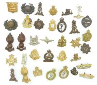 Small collection of British Army metal badges including Royal Marines, Royal Engineers, Ordnance