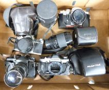 Five SLR cameras comprising Olympus OM20 body, Canon AV-1 with 50mm 1:1.8 lens, Praktica MTL 50 with