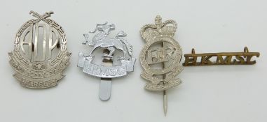 Four Hong Kong related metal badges including Hong Kong Military Service Corps examples