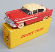 Dinky Toys diecast model Hudson Hornet Sedan with red body and cream roof, side stripe, hubs and