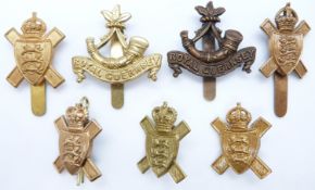 Seven British Army Royal Guernsey Light Infantry cap and collar badges