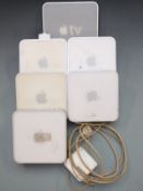 Five Apple Mac Mini computers together with an Apple TV A7278 unit and a Macbook charger.
