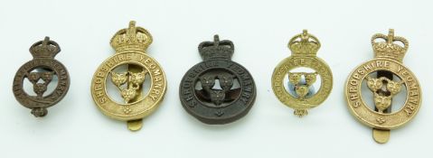 Five British Army Shropshire Yeomanry metal badges including a bronze example