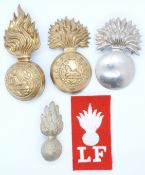 Four British Army Lancashire Fusiliers / Fusiliers metal badges and a cloth patch example