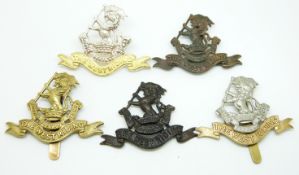 Five British Army West Riding Regiment metal cap badges including an officer's gilt example