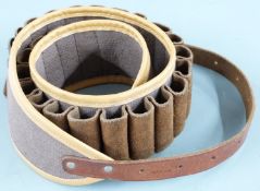 A 20 bore canvas and brown leather cartridge belt.