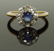An 18ct gold ring set with a sapphire surrounded by old cut diamonds, size M, 2.86g