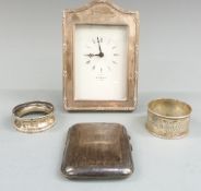 Kitney & Co. hallmarked silver mounted clock, two hallmarked silver napkin rings and a hallmarked