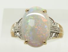 A 9ct gold ring set with an oval cabochon black opal of approximately 3.1ct and diamonds, 3.2g, size