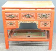 Oriental red lacquer desk with carved and pierced decoration highlighted in gilt and painted