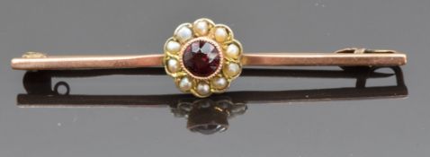 A 9ct gold brooch set with a garnet and seed pearls, 2.5g, 5cm