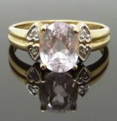 A 9ct gold ring set with an oval cut morganite and diamonds, size N, 2.77g