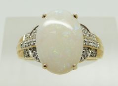 A 9ct gold ring set with an oval opal and diamonds, 2.9g, size N