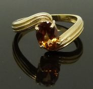 A 9ct gold ring set with an oval cut citrine, size N, 3.21g
