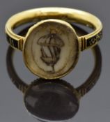 Georgian mourning ring set with an ivory plaque depicting an acorn and a black enamel band reading 