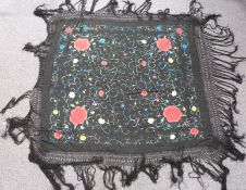 A 19th/20thC Chinese black shawl with embroidered chrysanthemum decoration and long fringe, 210 x