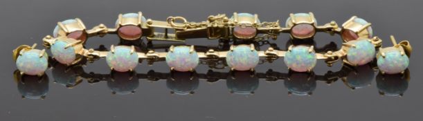 A 14ct gold gold bracelet set with opals and a matching pair of earrings