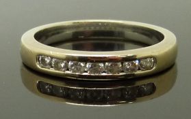 An 18ct gold diamond half eternity ring set with seven diamonds, size N, 4.00g