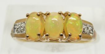 A 9ct gold ring set with three opal cabochons and diamonds, 2.3g, size N