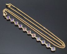 A 9ct gold pendant set with amethyst, garnets and tanzanite on a 9ct gold chain, 6.1g