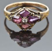 Georgian / Victorian rose gold ring marked 12 set with an old cut diamond and garnets on an engraved