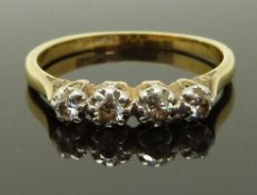 An 18ct gold ring set with four diamonds in a platinum setting, size R/S, 3.00g