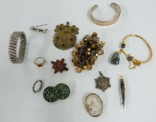 A collection of jewellery including silver bangle, pressed amber brooch, paste bracelet, silver fob,