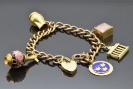 A 9ct gold charm bracelet with four 9ct gold charms one in the form of a vase, a jug, a Swedish